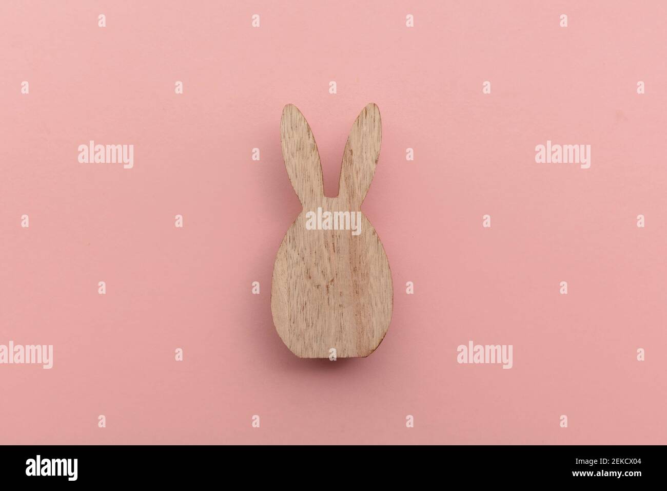 Minimal easter holiday background Wooden easter bunny on pink Stock Minimal easter holiday background Wooden easter bunny on pink Stock