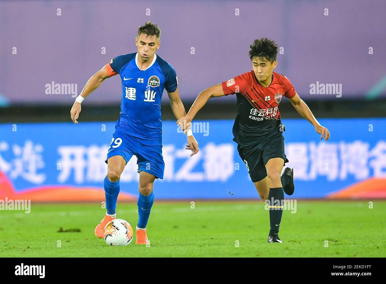 Brazilian football player Olivio da Rosa, also known as Ivo, of Henan Jianye F.C., left, protects the ball during the fourth-round match of 2020 Chinese Super League (CSL) against Shenzhen F.C., Dalian city, northeast China's Liaoning province, 10 August 2020. Shenzhen F.C. was defeated by Henan Jianye F.C. with 1-2. Stock Photo