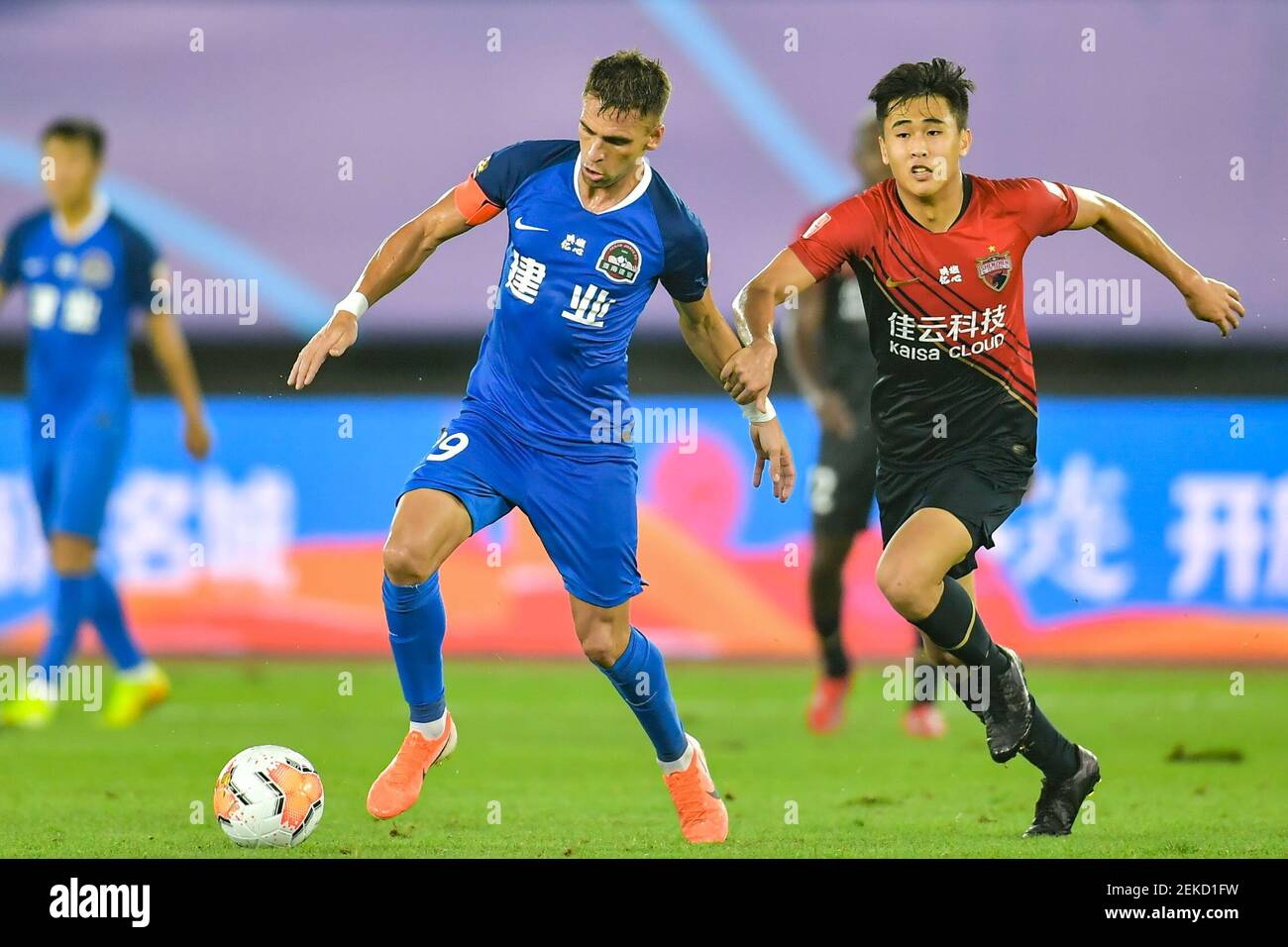 Brazilian football player Olivio da Rosa, also known as Ivo, of Henan Jianye F.C., left, protects the ball during the fourth-round match of 2020 Chinese Super League (CSL) against Shenzhen F.C., Dalian city, northeast China's Liaoning province, 10 August 2020. Shenzhen F.C. was defeated by Henan Jianye F.C. with 1-2. Stock Photo