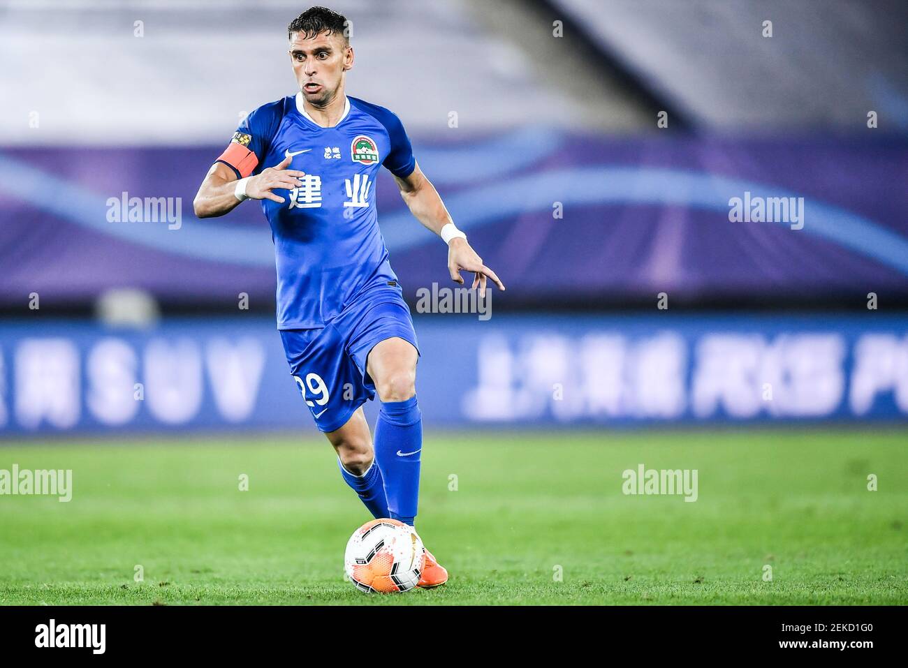 Brazilian football player Olivio da Rosa, also known as Ivo, of Henan Jianye F.C. keeps the ball during the fourth-round match of 2020 Chinese Super League (CSL) against Shenzhen F.C., Dalian city, northeast China's Liaoning province, 10 August 2020. Shenzhen F.C. was defeated by Henan Jianye F.C. with 1-2. Stock Photo