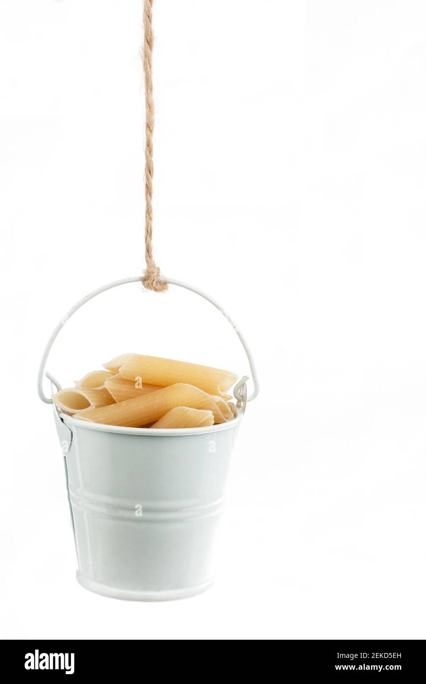 A full bucket of pasta hanging from a rope. White background Stock