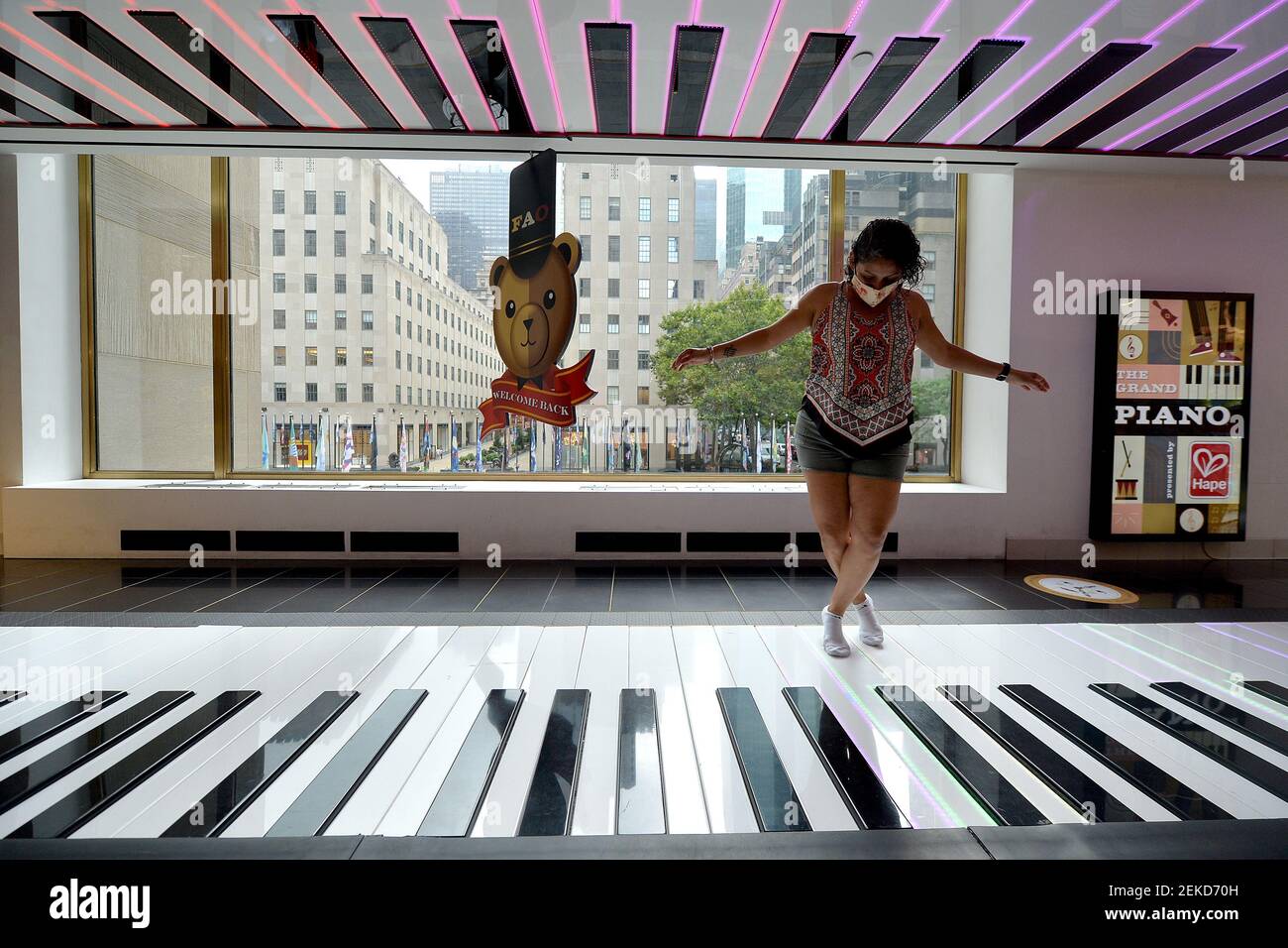 Liza Slack, visiting from Florida, plays on the large toe tap floor piano,  made famous in the movie “Big” at the newly reopened famed toy store FAO  Schwarz at Rockefeller Center in