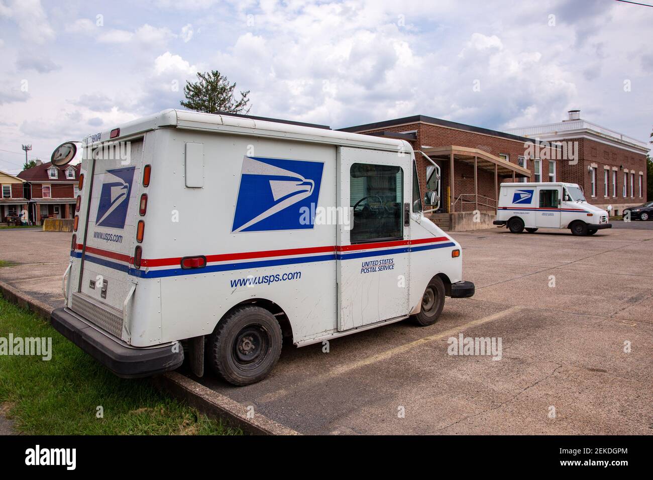 United States Postal Service (USPS) delivery vehicles are parked at the