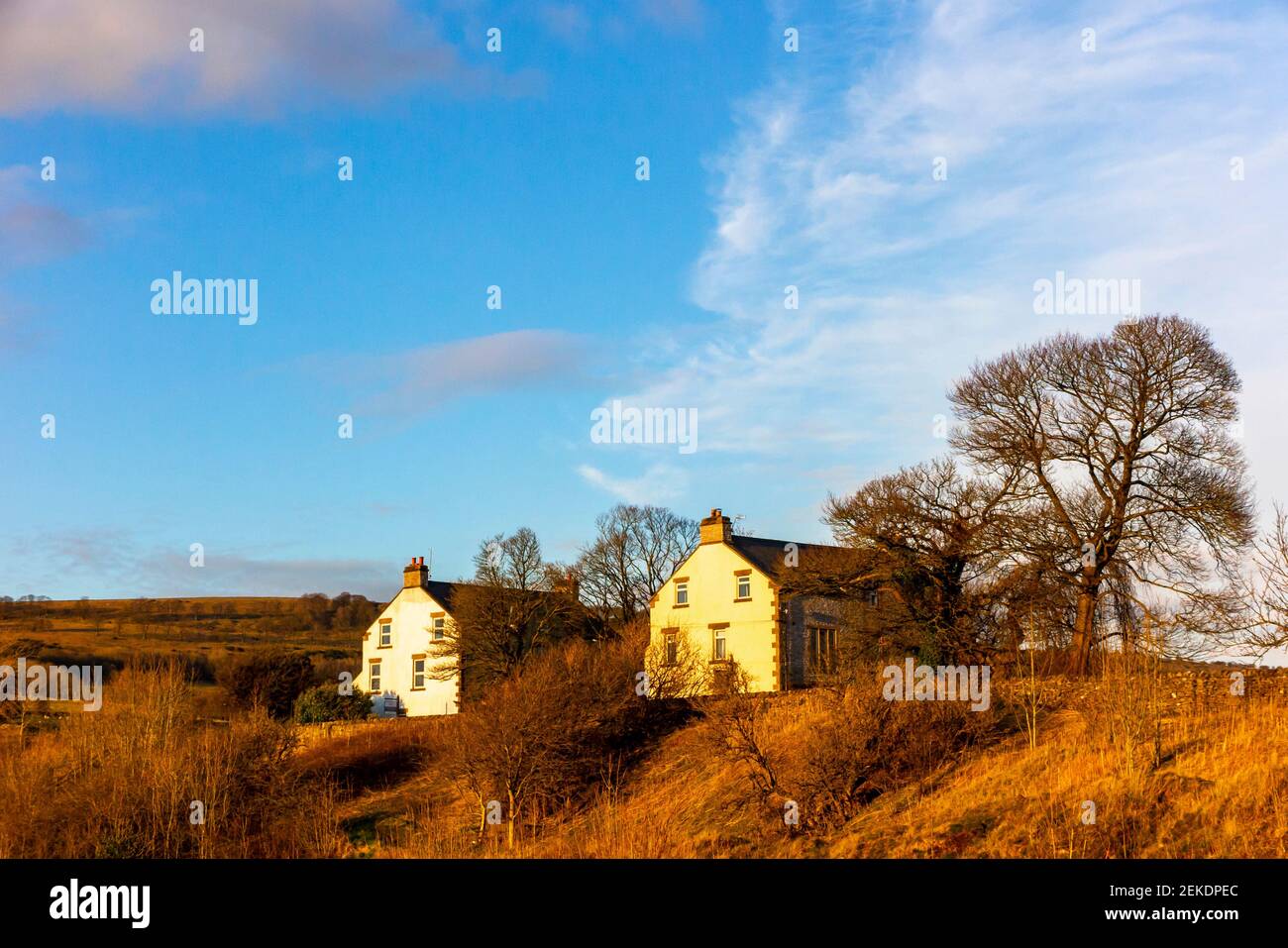 Late afternoon sunshine in winter with houses at Monsal Head in the Peak District National Park Derbyshire Dales England UK Stock Photo