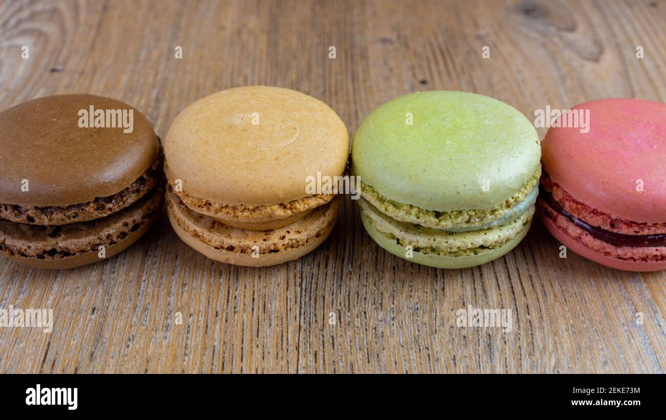 fresh colorful macarons lined, raspberry, chocolate, hazelnut, pistachio Stock Photo