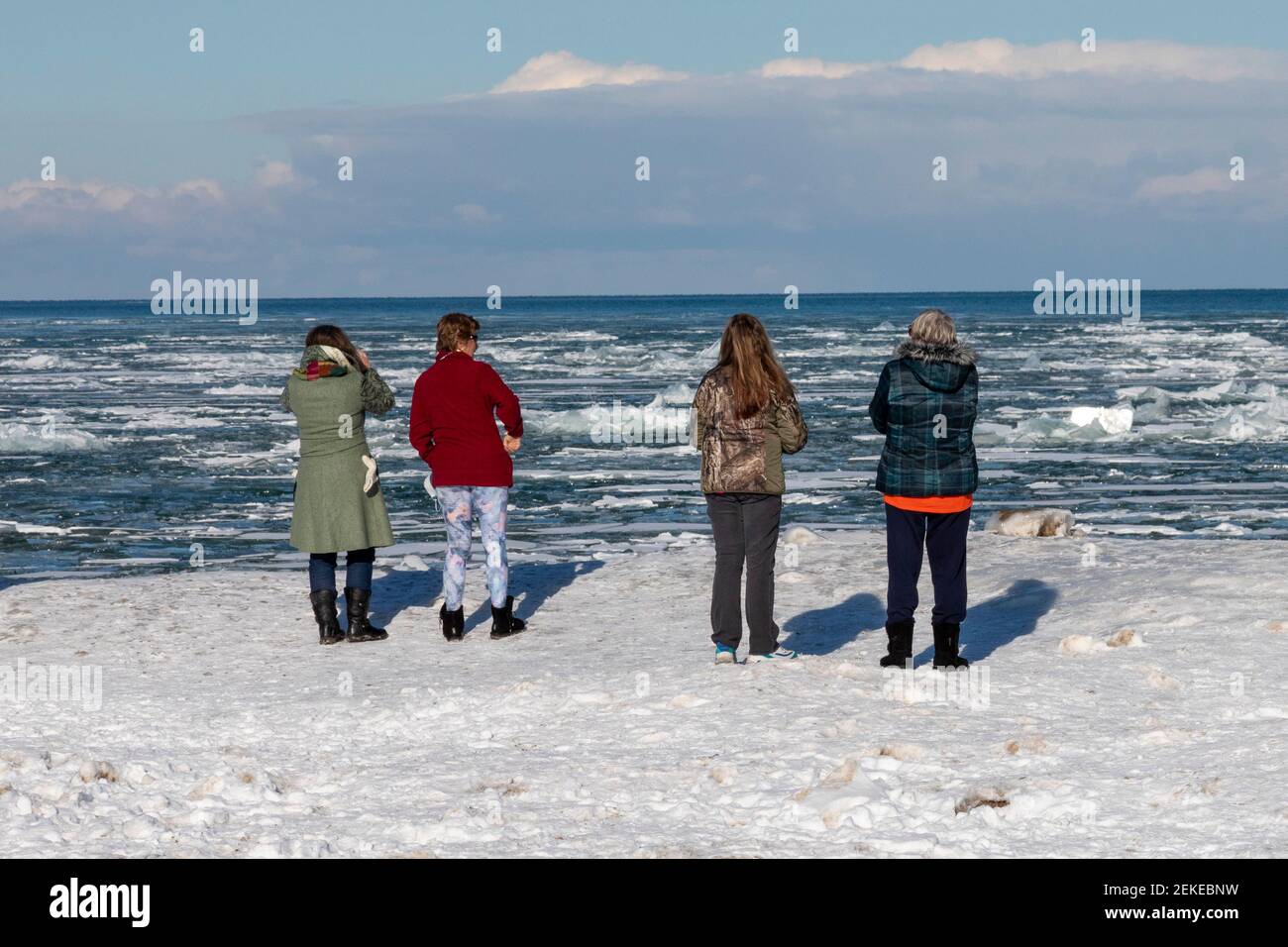 Port Sanilac, Michigan - People view ice on Lake Huron at the Port Sanilac Harbor. Stock Photo