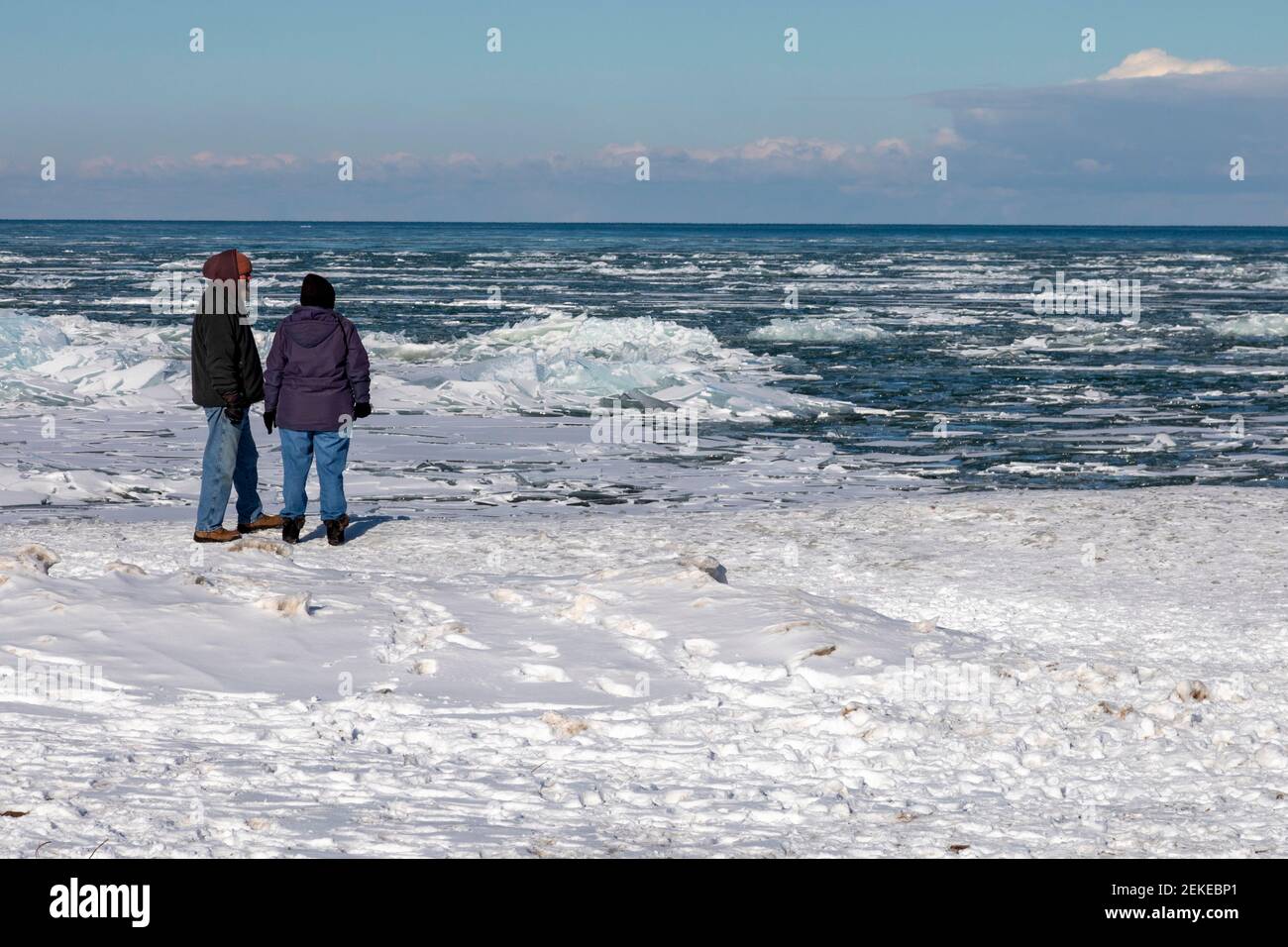 Port Sanilac, Michigan - People view ice on Lake Huron at the Port Sanilac Harbor. Stock Photo