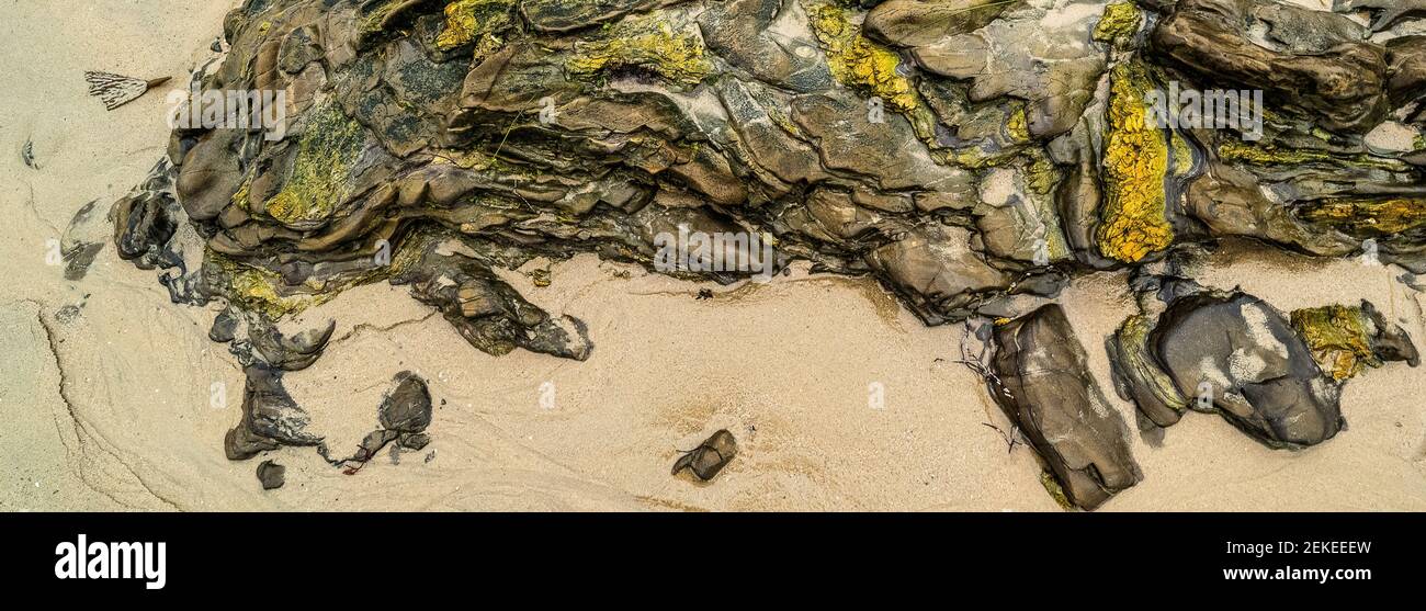 Eroded rock formation on sandy beach, Crystal Cove State Park, Newport Beach, California, USA Stock Photo