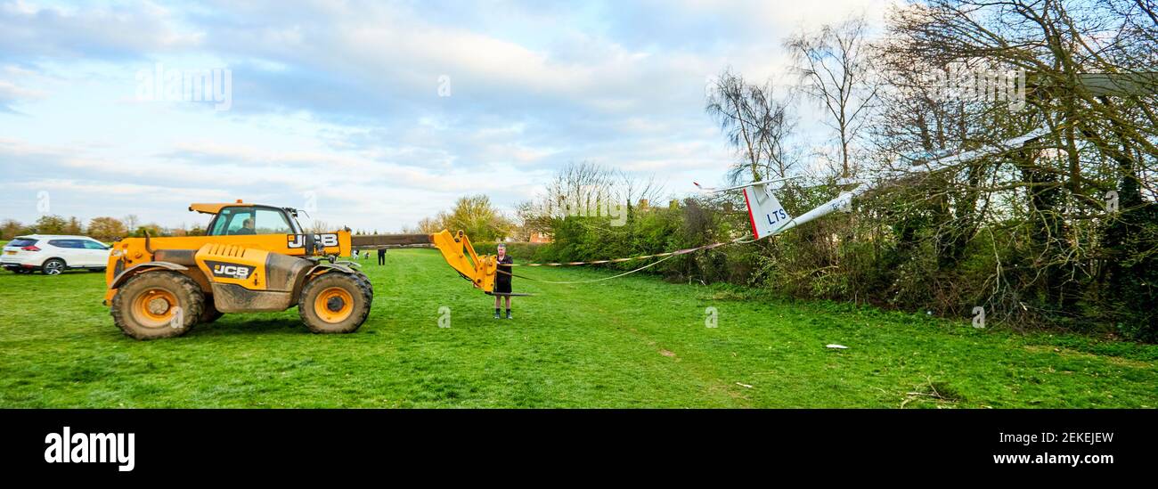 A JCB telehandler is used to recover a Schempp-Hirth Arcus T glider after it crashed into trees in Caversfield Park near Bicester. The pilot escaped uninjured. Stock Photo