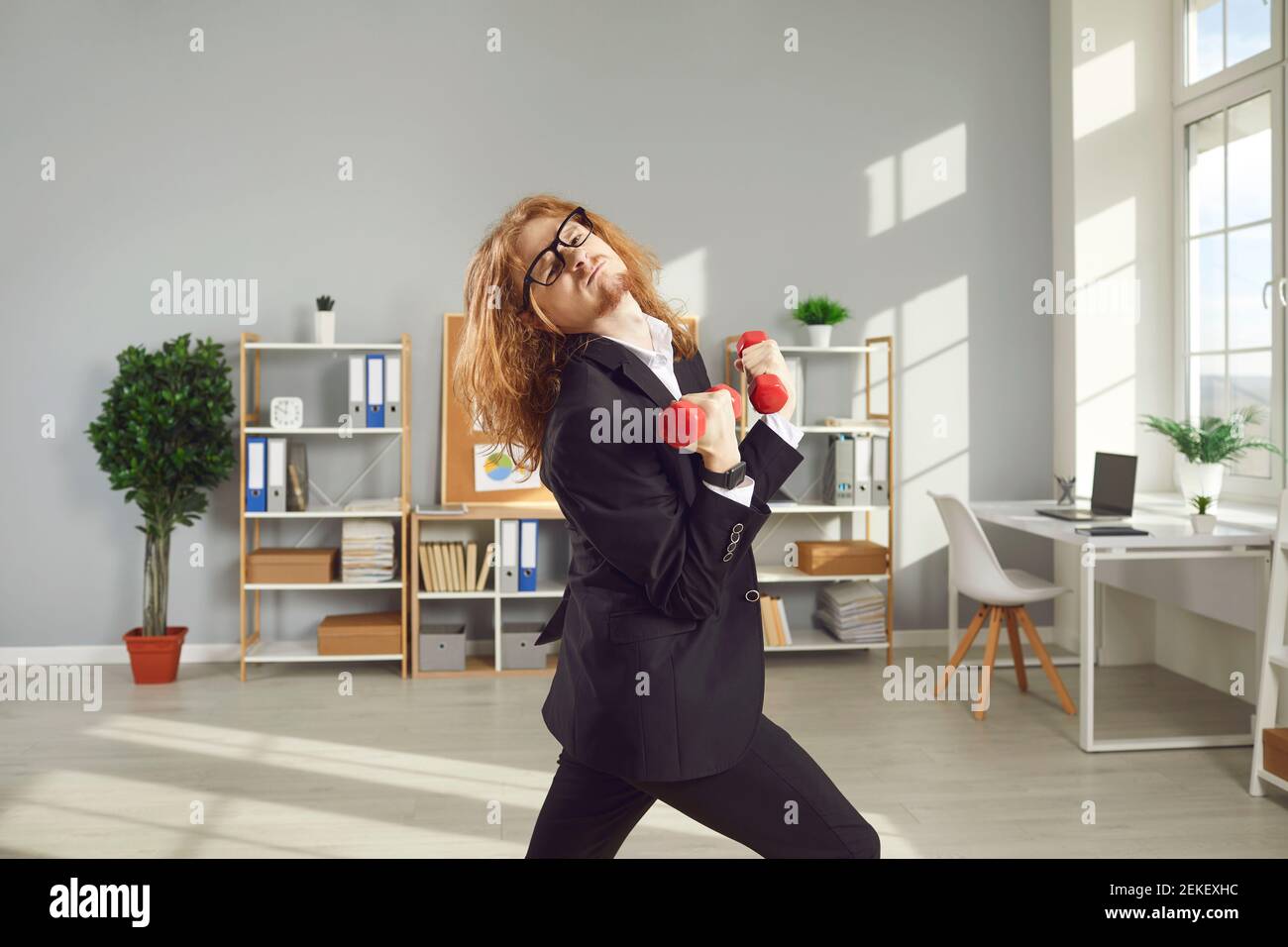 Funny businessman or office worker leading hectic busy lifestyle but keeping fit anyway Stock Photo