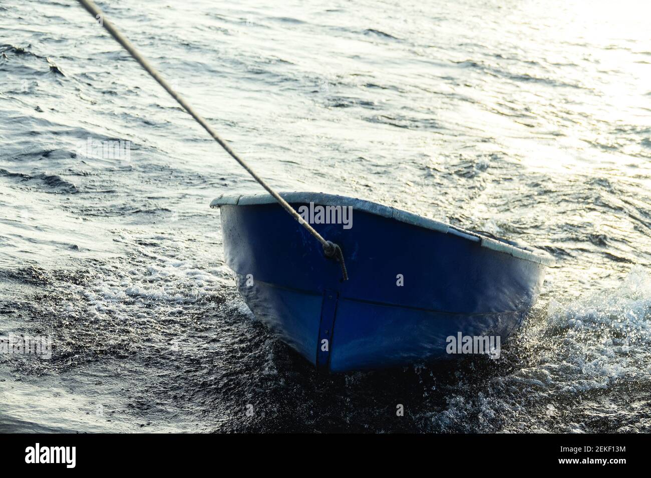boat is tethered behind fishing schooner, on trailers, under tow Stock Photo