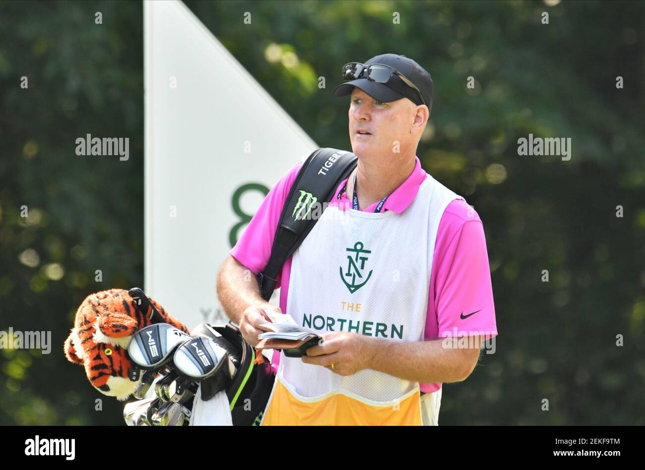 Tiger Woods and caddie Joe LaCava walk out of the pine straw on the front  nine in the fourth round of the Masters at Augusta National on April 14,  2013 in Augusta,