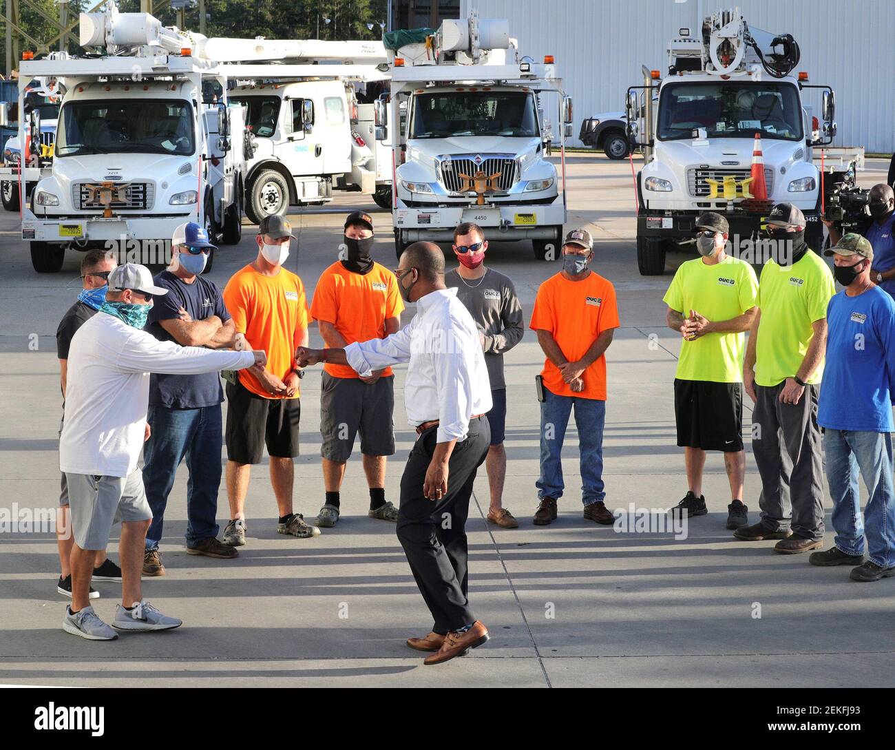 Orlando Utilities Commission vice president LeMoyne Adams, center, thanks lineworkers during a meeting before their departure from OUC's Pershing Operations Center in Orlando, Fla. for Lafayette, La., Thursday, Aug. 27, 2020. A dozen OUC workers volunteered to assist with power restoration efforts in the wake of the devastation from Hurricane Laura that struck the Louisiana coastline Thursday morning. The lineworkers will join up with other municipal utilities from across the U.S. as a part of a coordinated mutual aid response to the category 4 hurricane. (Photo by Joe Burbank/Orlando Sentinel Stock Photo