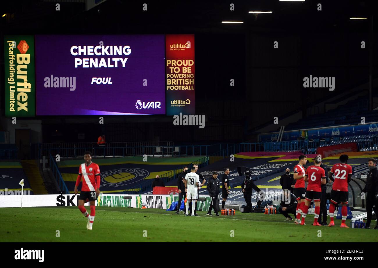 Referee Andre Marriner uses the pitch side VAR monitor before deciding to overturn his penalty decision during the Premier League match at Elland Road, Leeds. Picture date: Tuesday February 23, 2021. Stock Photo