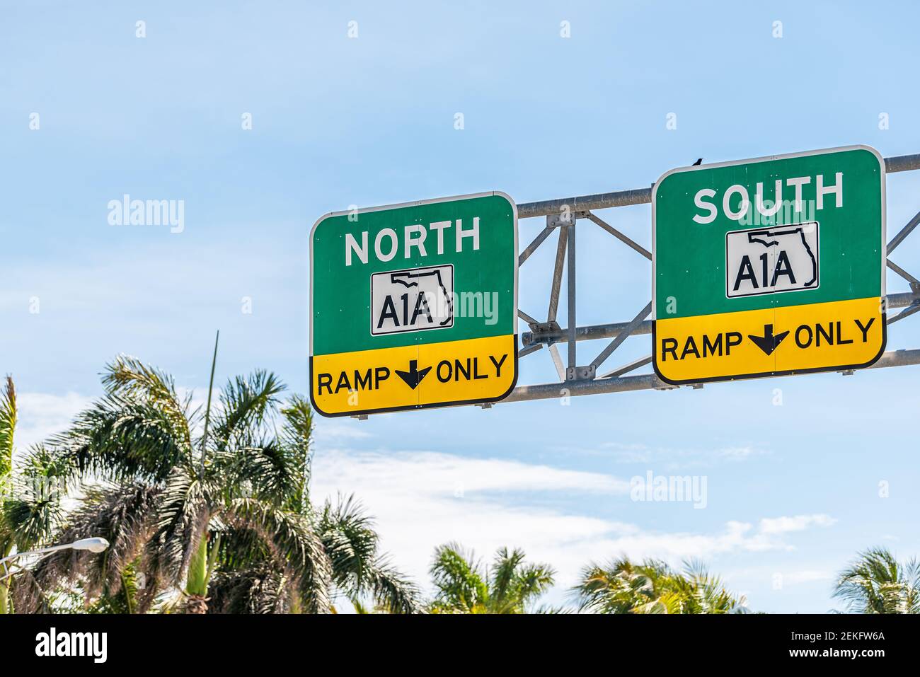 Florida state road highway street A1A to North or South ramp only direction signs in Miami Dade county with palm trees and blue sky Stock Photo