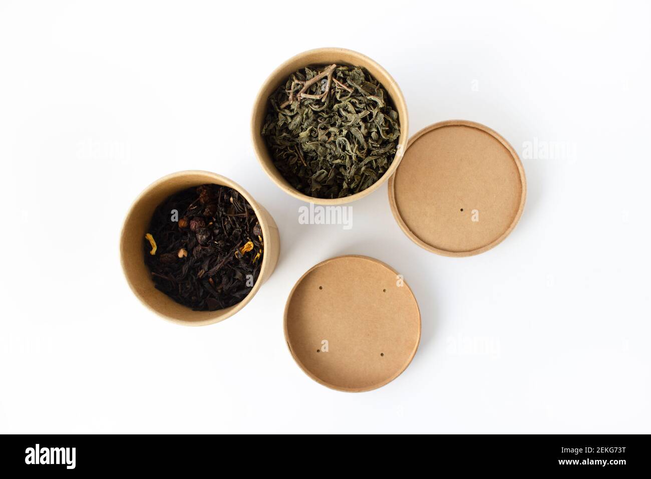 Green and black tea in reusable round cardboard packaging isolated on ...