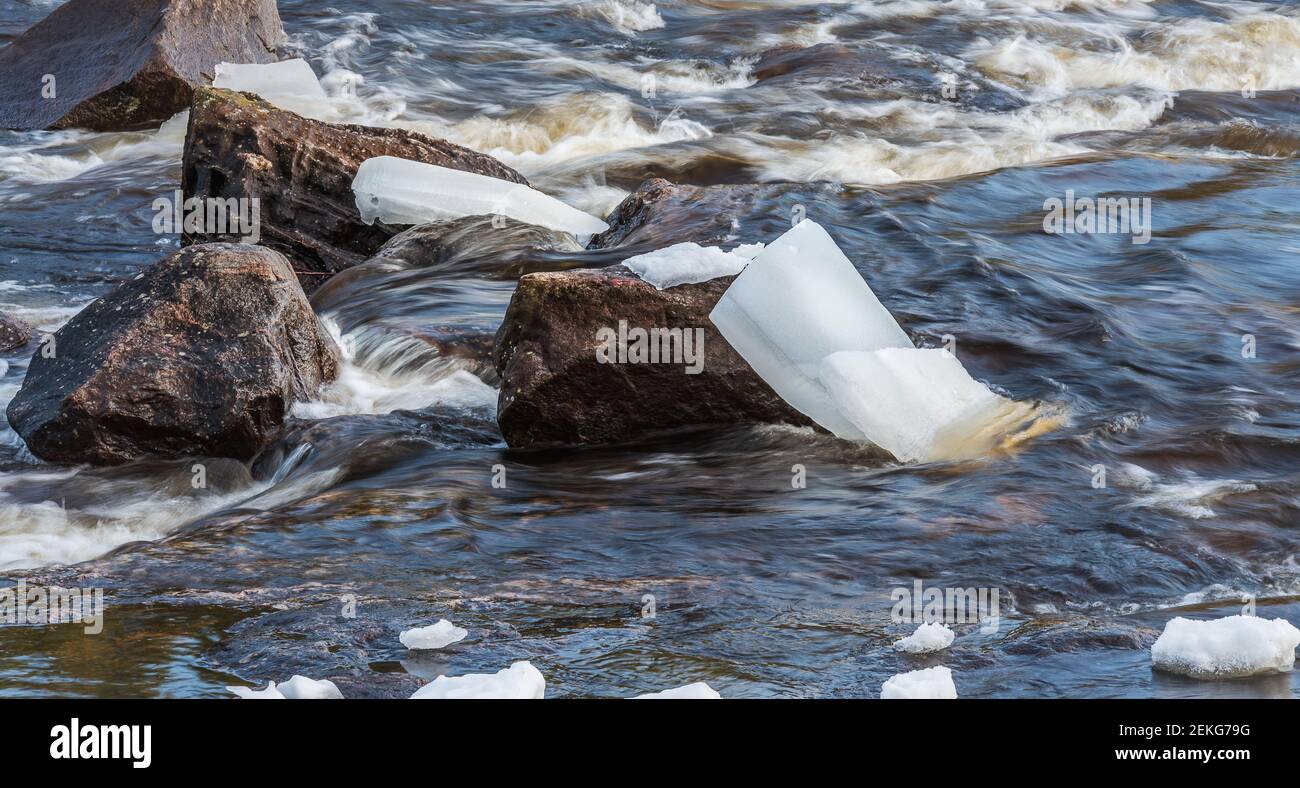 The Swedish river in the spring with ice blocks stuck on the rocks Stock Photo