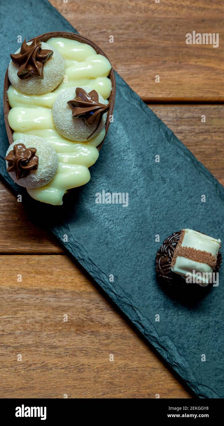 Chocolate easter egg on top of black stone Stock Photo