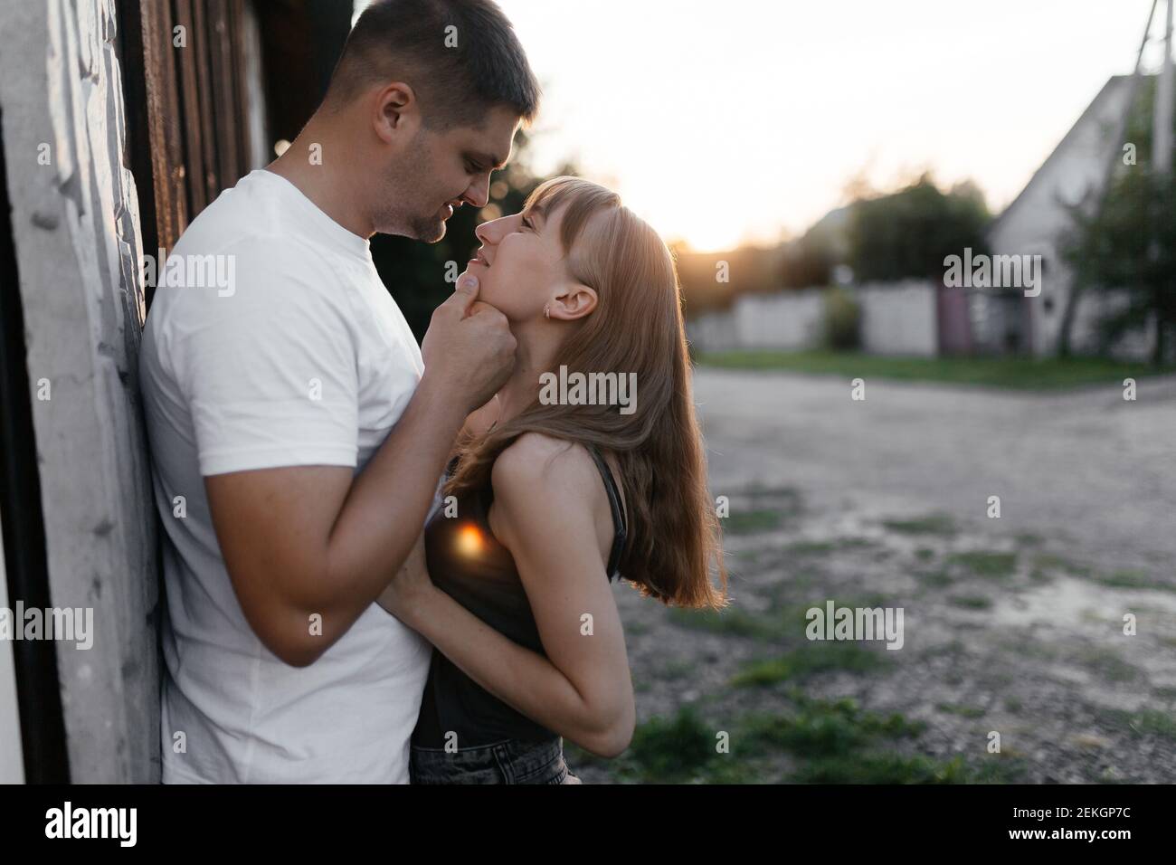 Husband going to kiss his wife. Man and woman kissing at the sunset. Happy couple on the street.  Stock Photo
