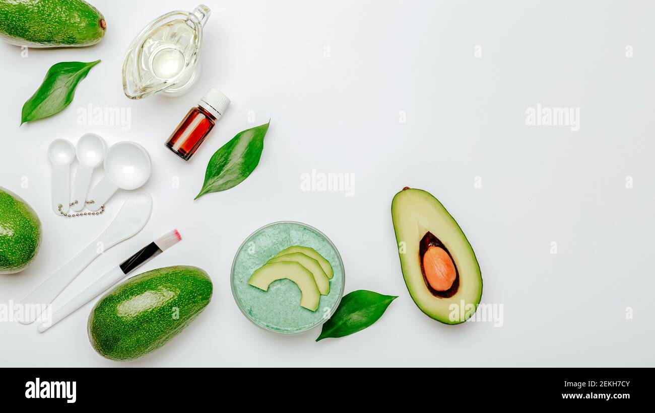 Face mask or Body Scrub bath products hand made diy from avocado fruit. Skin care beauty product natural organic cosmetics made from avocado oil, esse Stock Photo
