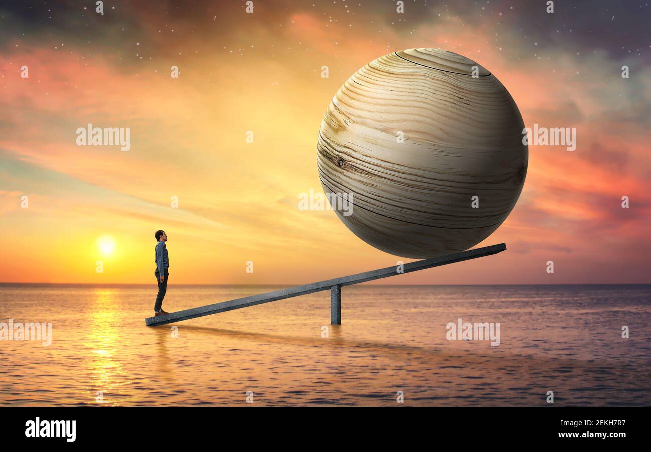 Balance concept of man and big wooden ball. Stock Photo