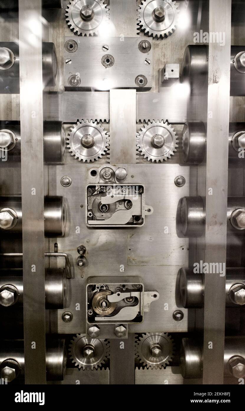 Inside of large bank vault door showing gears and bolts of steel.  Graphic for security, safety, protection. Stock Photo