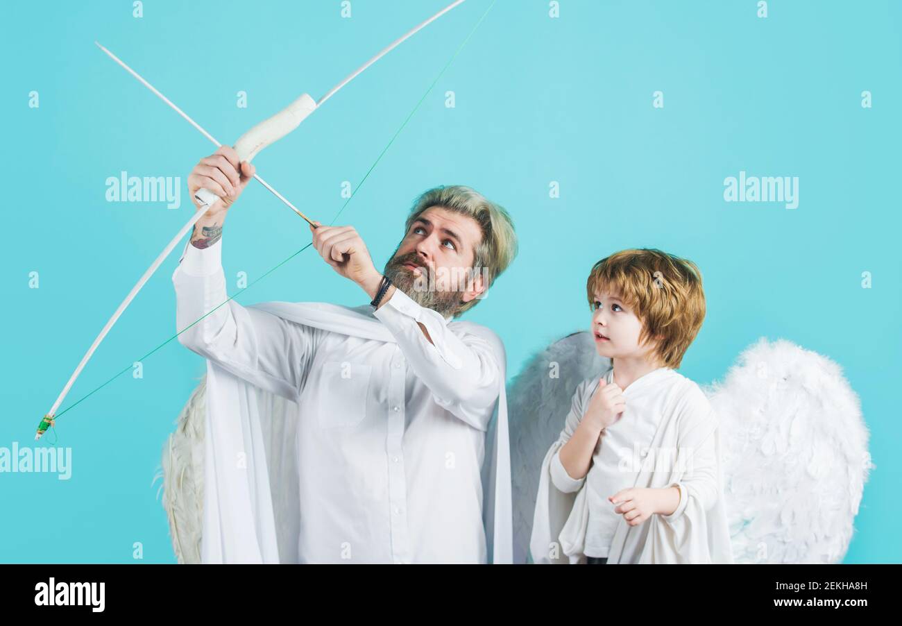Father with son angels. Angel bow. Valentines day. Cupid with bow and arrow. Arrows of love. Stock Photo