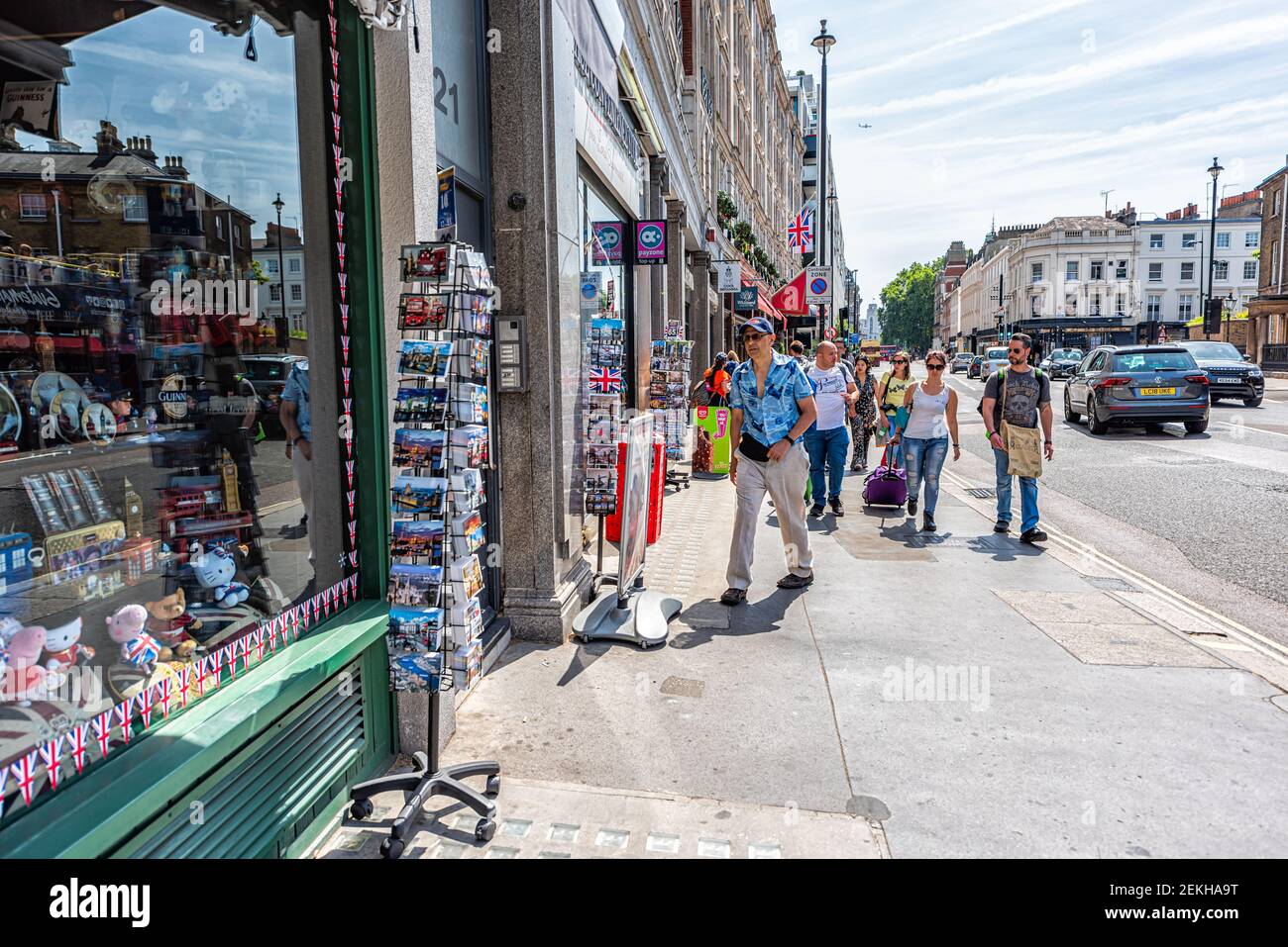 London, UK - June 24, 2018: Gift store shop with people walking on sidewalk street by many souvenirs in summer in United Kingdom Stock Photo