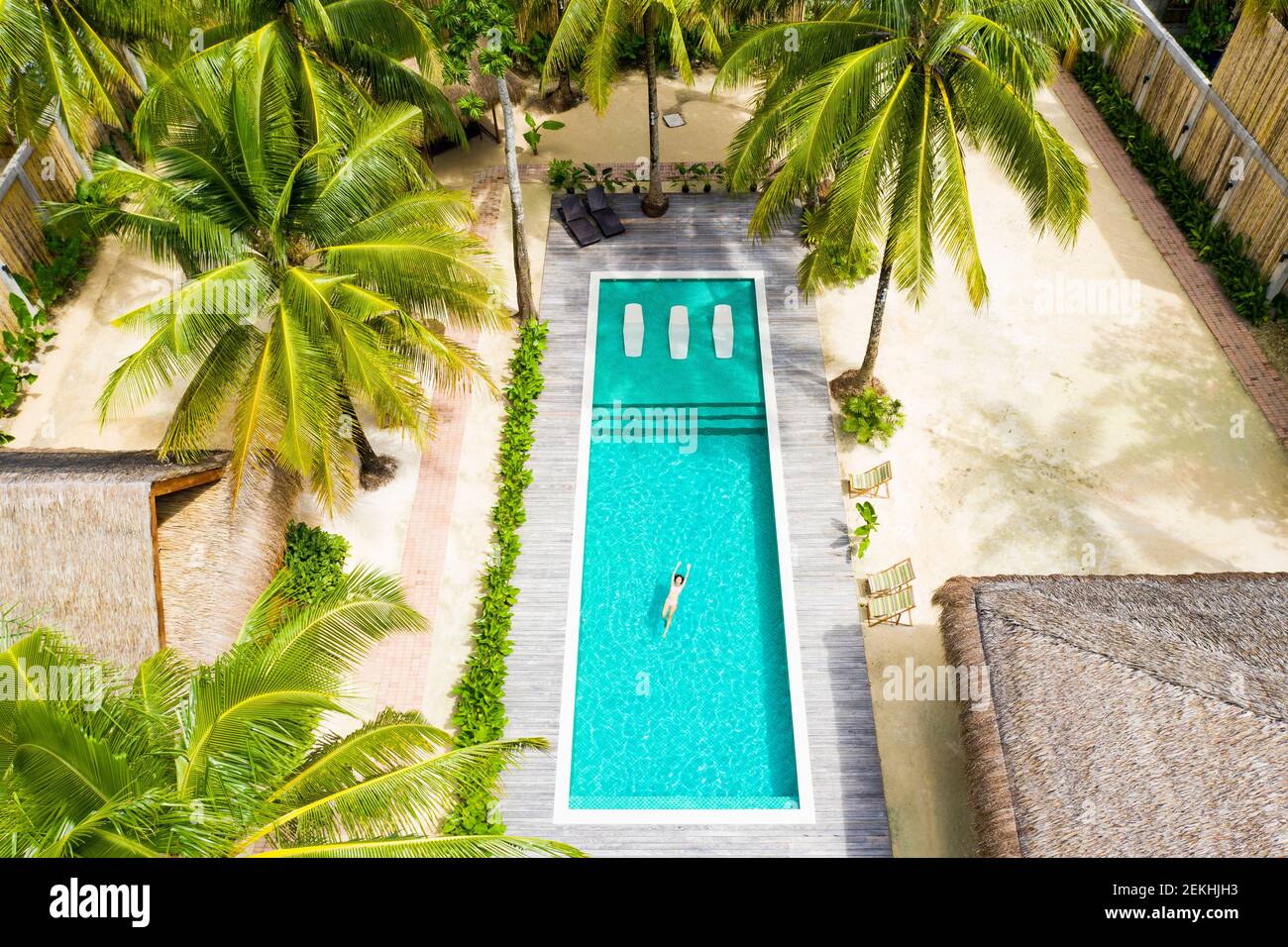 Aerial view of a girl swimming in a pool during the Covid-19 outbreak. Stock Photo