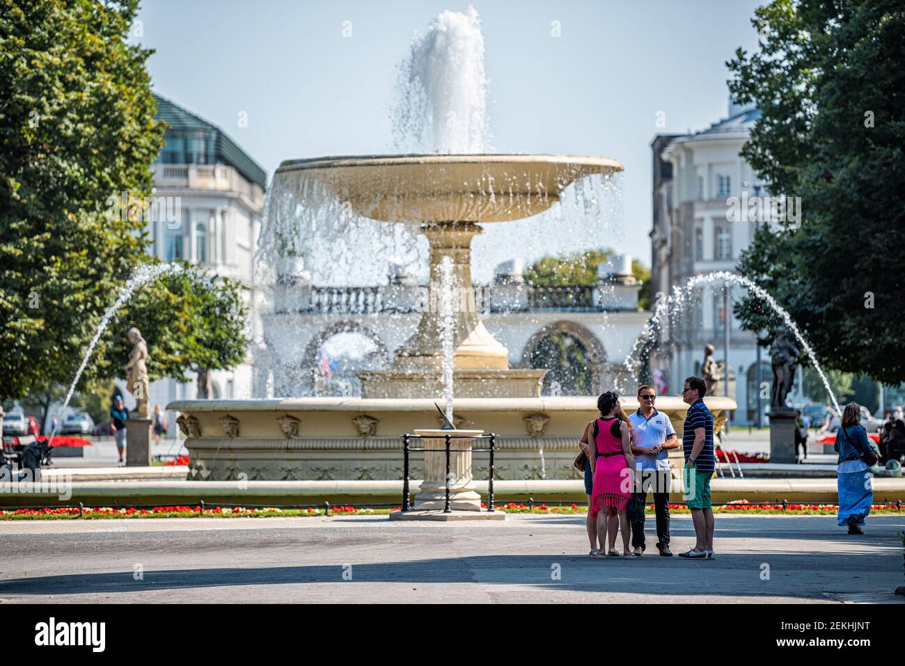 Warsaw, Poland - August 23, 2018: Tourists people by water fountain square in summer Saxon Gardens Park with spraying splashing sculptures Stock Photo