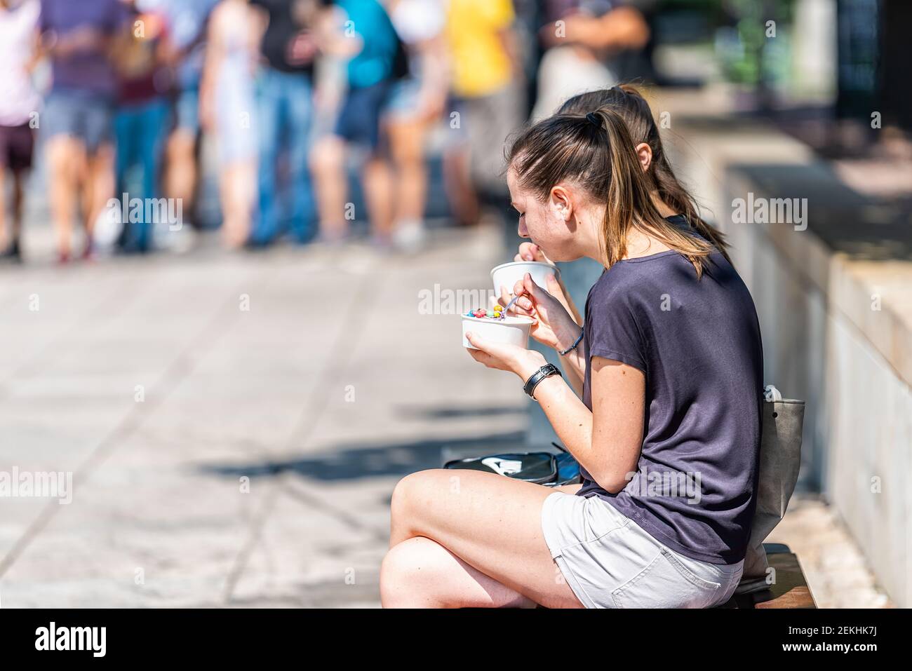 Warsaw, Poland - August 23, 2018: Old town historic street in capital city during sunny summer day Krakowskie Przedmiescie and people women eating ice Stock Photo