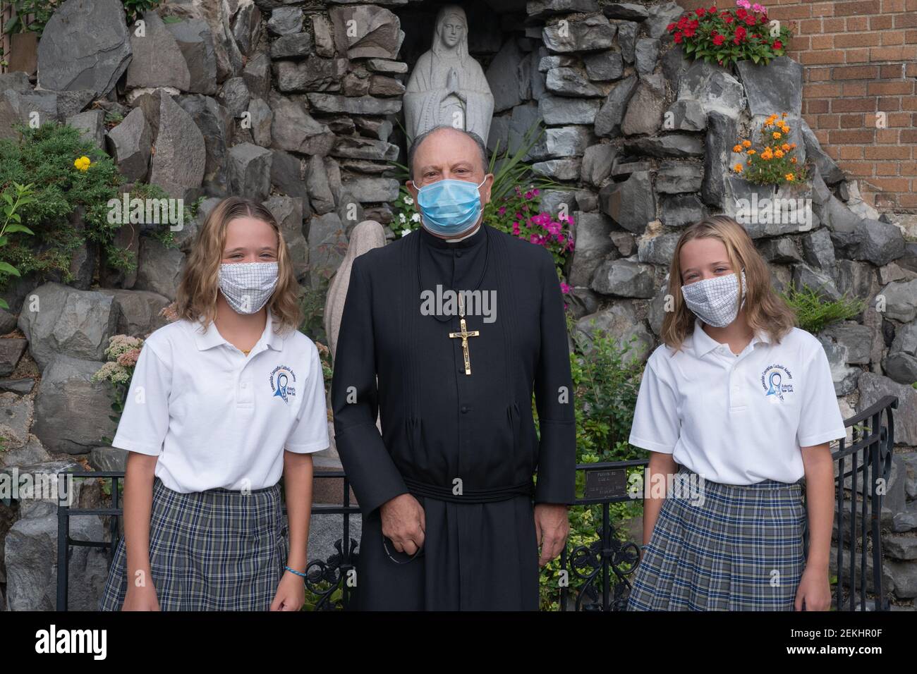 Principal Brother Joseph Rocco poses for a photo with students on the