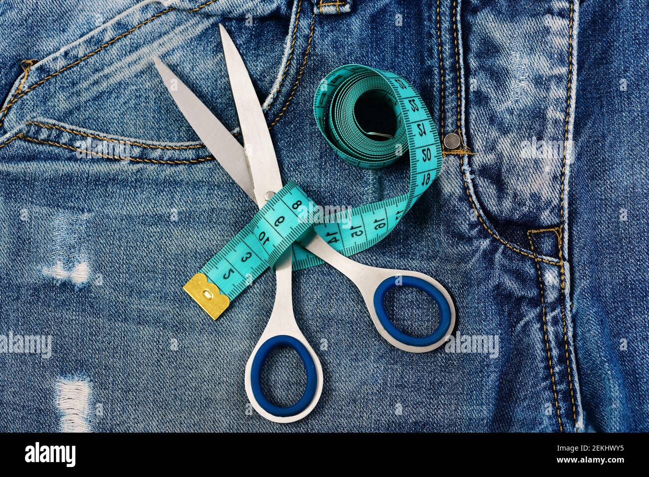 Premium Photo  Tailors tape measure on damaged denim