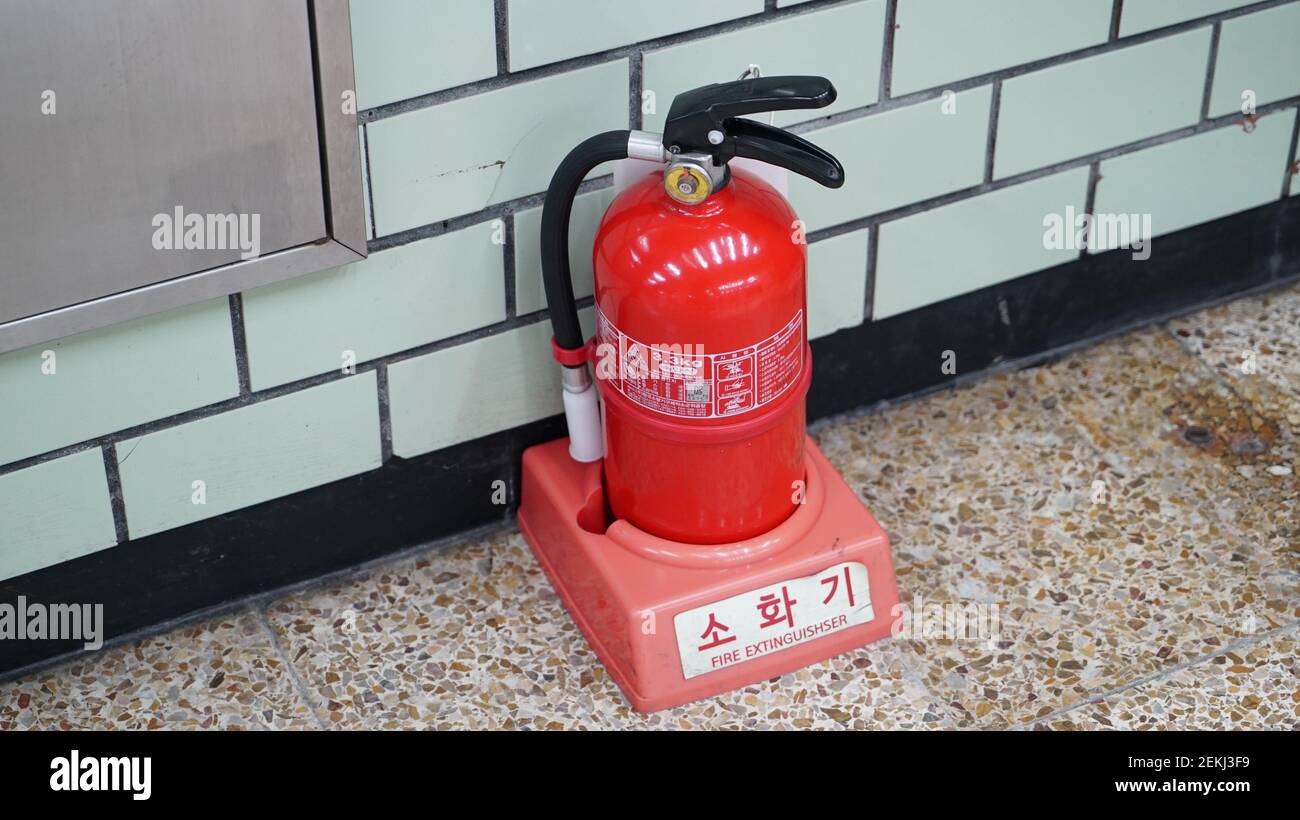 Fire extinguisher on the Subway Station Floor Stock Photo