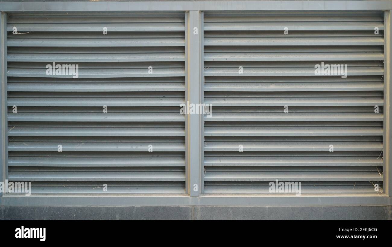 White vents on the exterior wall of a stone building Stock Photo