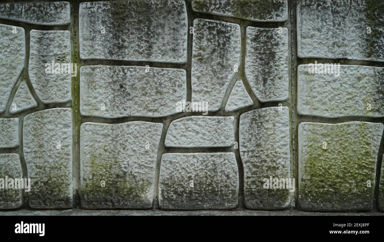 Mossy cracked old Stone wall texture Stock Photo