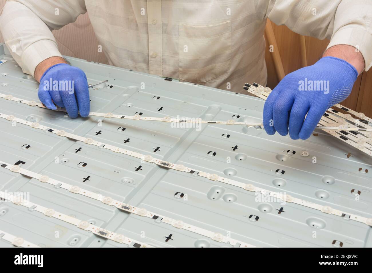 Repair of LCD TV. Replacing LED chambers on large monitor panel in service center. Stock Photo