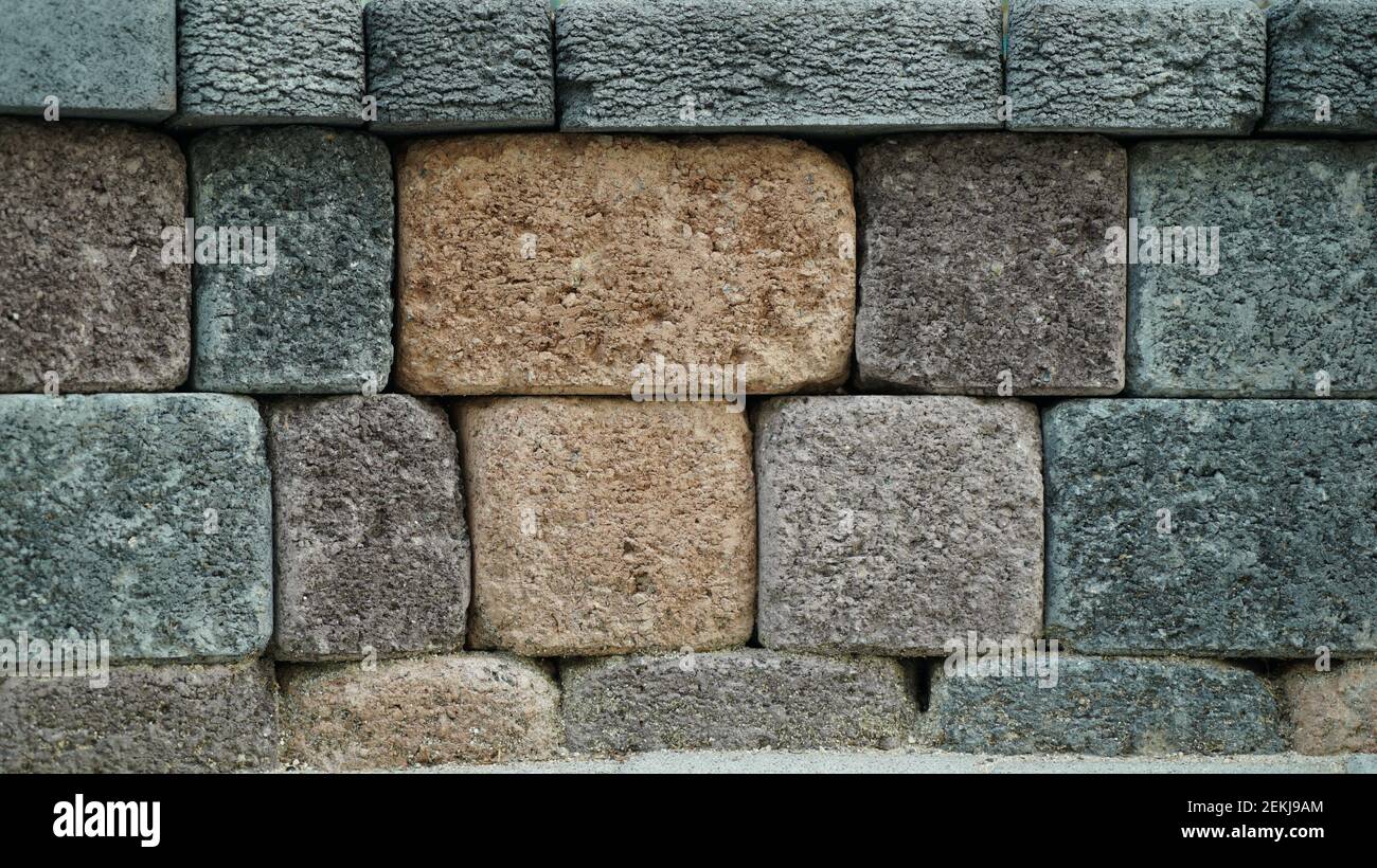 Wall texture with stacked colorful rocks Stock Photo - Alamy