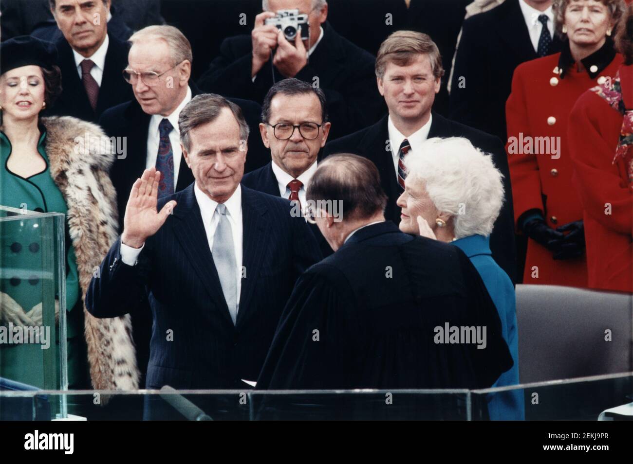 Chief Justice William Rehnquist administering Oath of Office to George Bush on west front of U.S. Capitol, with Dan Quayle and Barbara Bush looking on, Architect of the Capitol Collection, January 20, 1989 Stock Photo