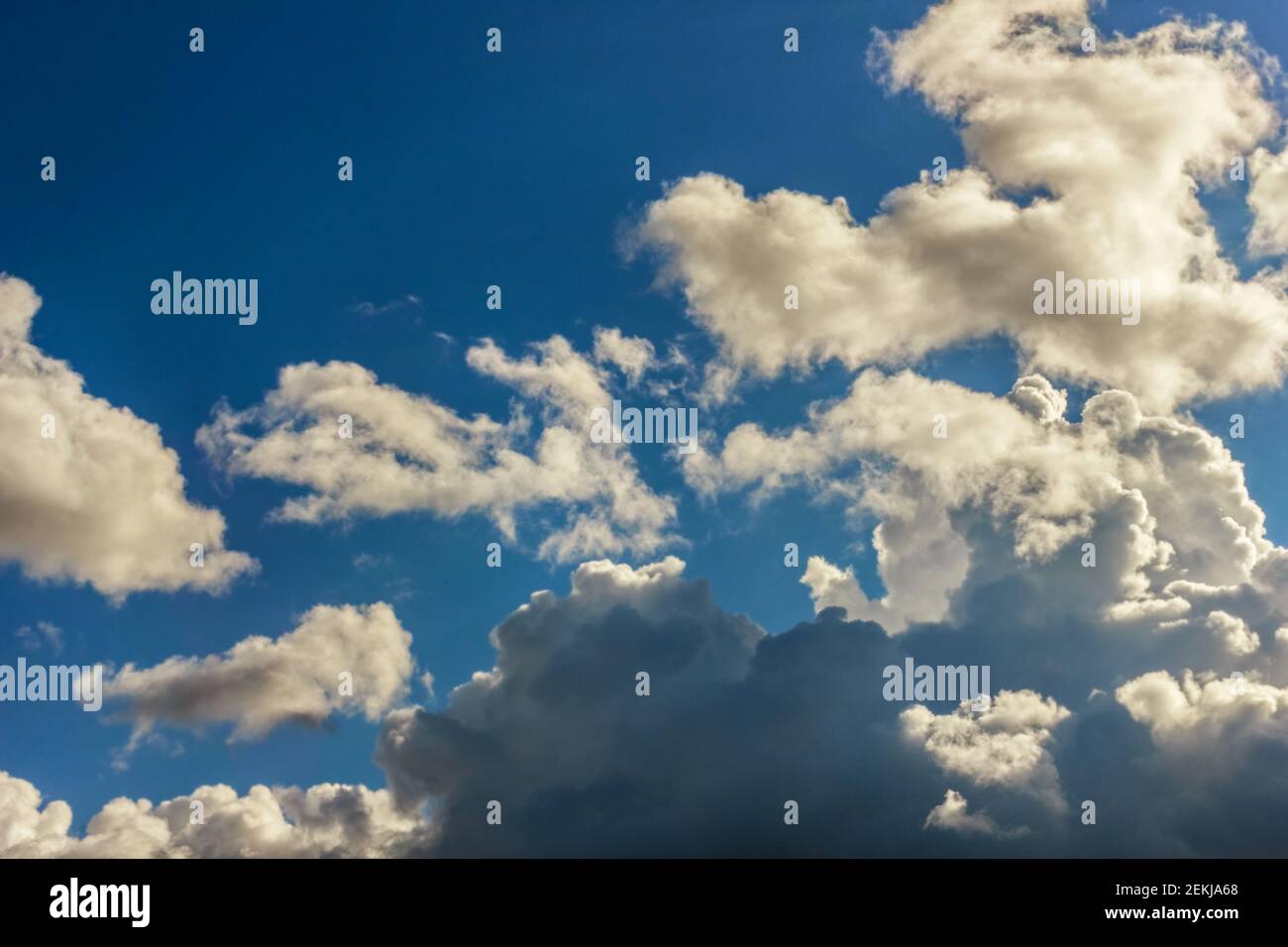 Real fun lush white clouds against blue sunny happy sky Stock Photo