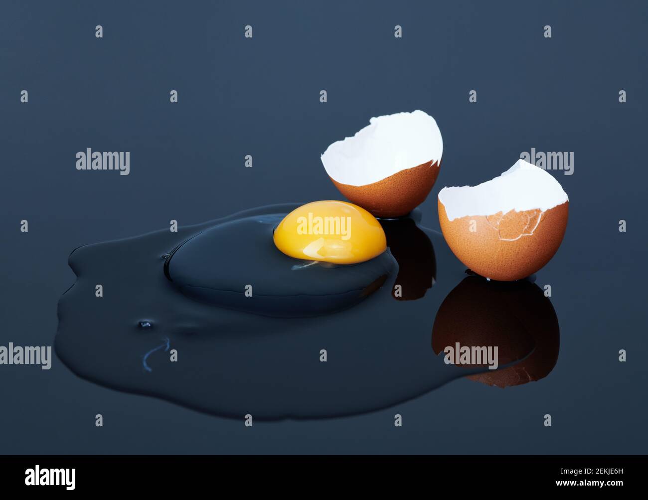 broken chicken eggs on a black background close up Stock Photo - Alamy