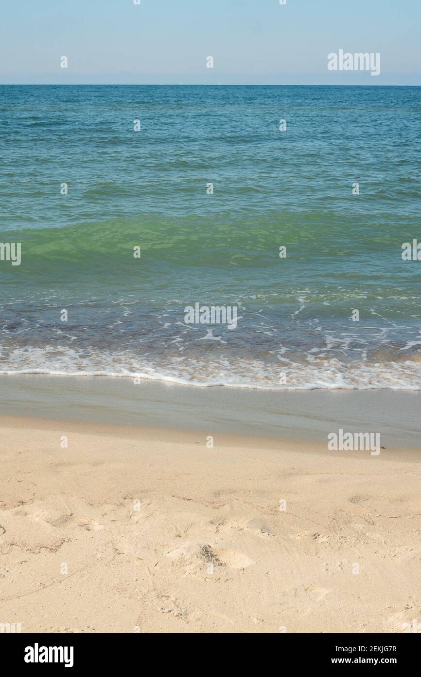 Seashore with  soft wave on sandy beach. Natural background for summer vacation. Stock Photo