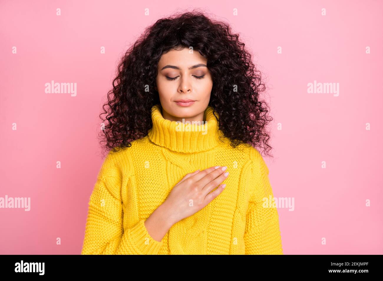 Photo of young attractive latin girl hand on chest calm peaceful isolated over pink color background Stock Photo