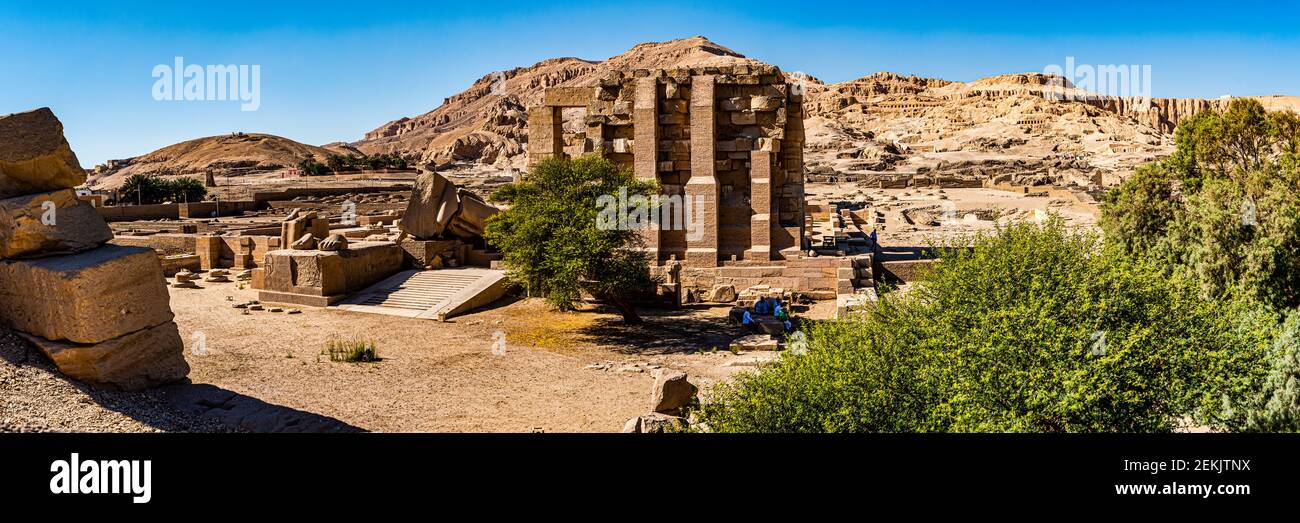 Ruins of Ramesseum Temple of Ramses II with Tombs of Nobles on far hillside, West Bank, Luxor, Egypt Stock Photo