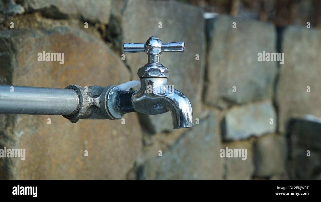 Faucet on the Stone Wall of the Promenade Stock Photo