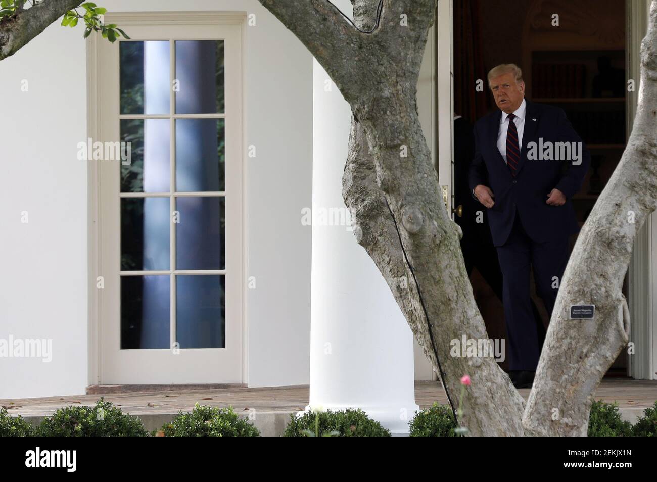 U.S. President Donald Trump walks out from the Oval Office of the White ...