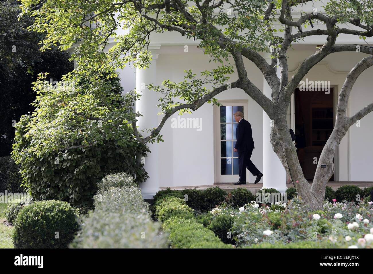 U.S. President Donald Trump walks out from the Oval Office of the White ...