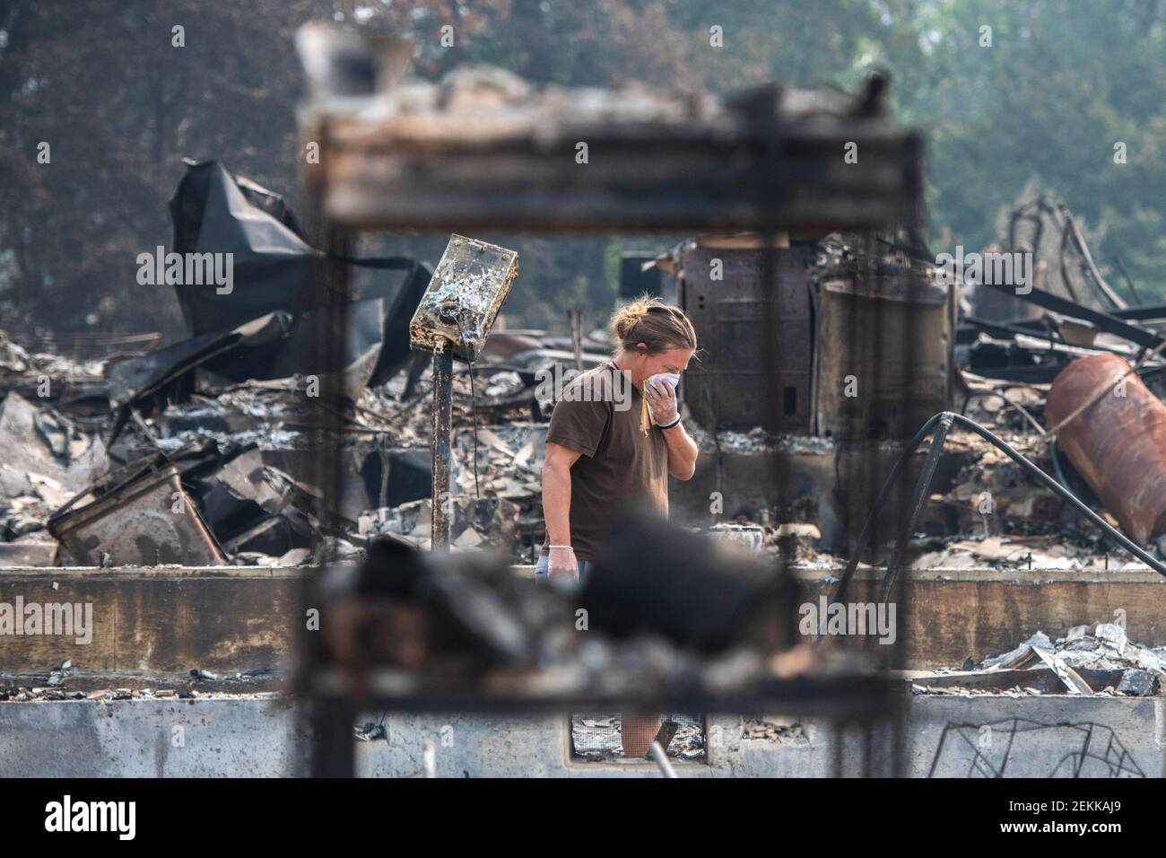 TALENT, ORE - SEPTEMBER 18, 2020: Zach Kuhlow checks the remnants of his house for anything salvagable. His son, who is now 10, was born inside the house. In Talent, about 20 miles north of the California border, homes were charred beyond recognition. Across the western US, at least 87 wildfires are burning, according to the National Interagency Fire Center. They've torched more than 4.7 million acres -- more than six times the area of Rhode Island. Credit: Chris Tuite/imageSPACE/Sipa USA Stock Photo