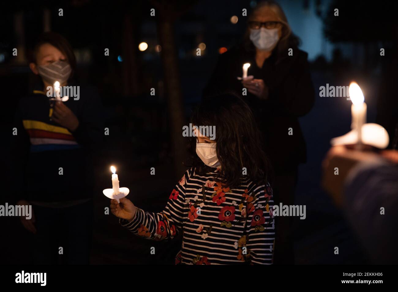 Mourners hold lit candles at a memorial in Dayton honouring the recent ...
