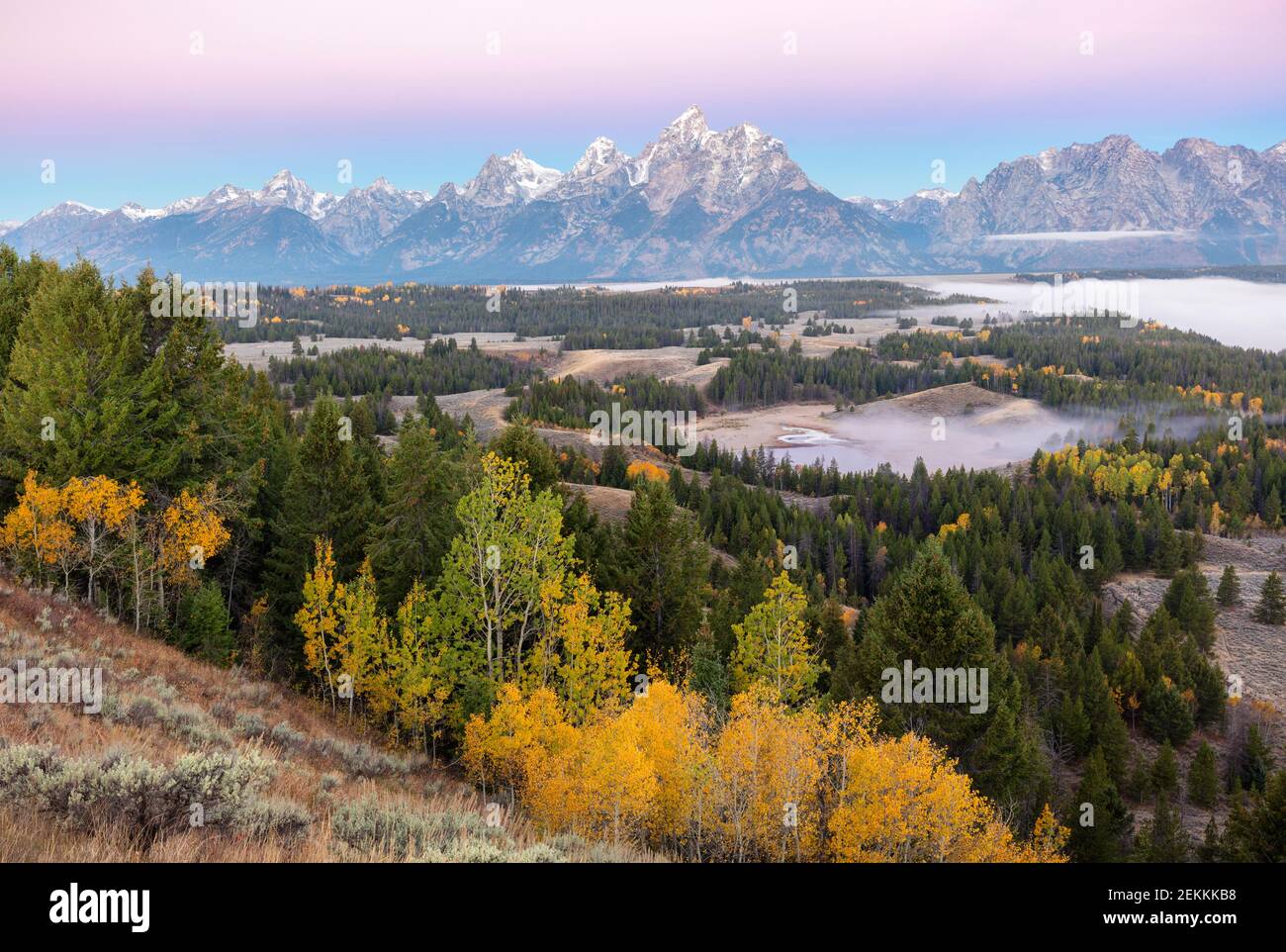 Grand Teton National Park, WY: Dawn light on the Teton Range with fog in the Snake River Valley Stock Photo